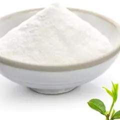 Bowl of L-theanine powder with a green tea leaf